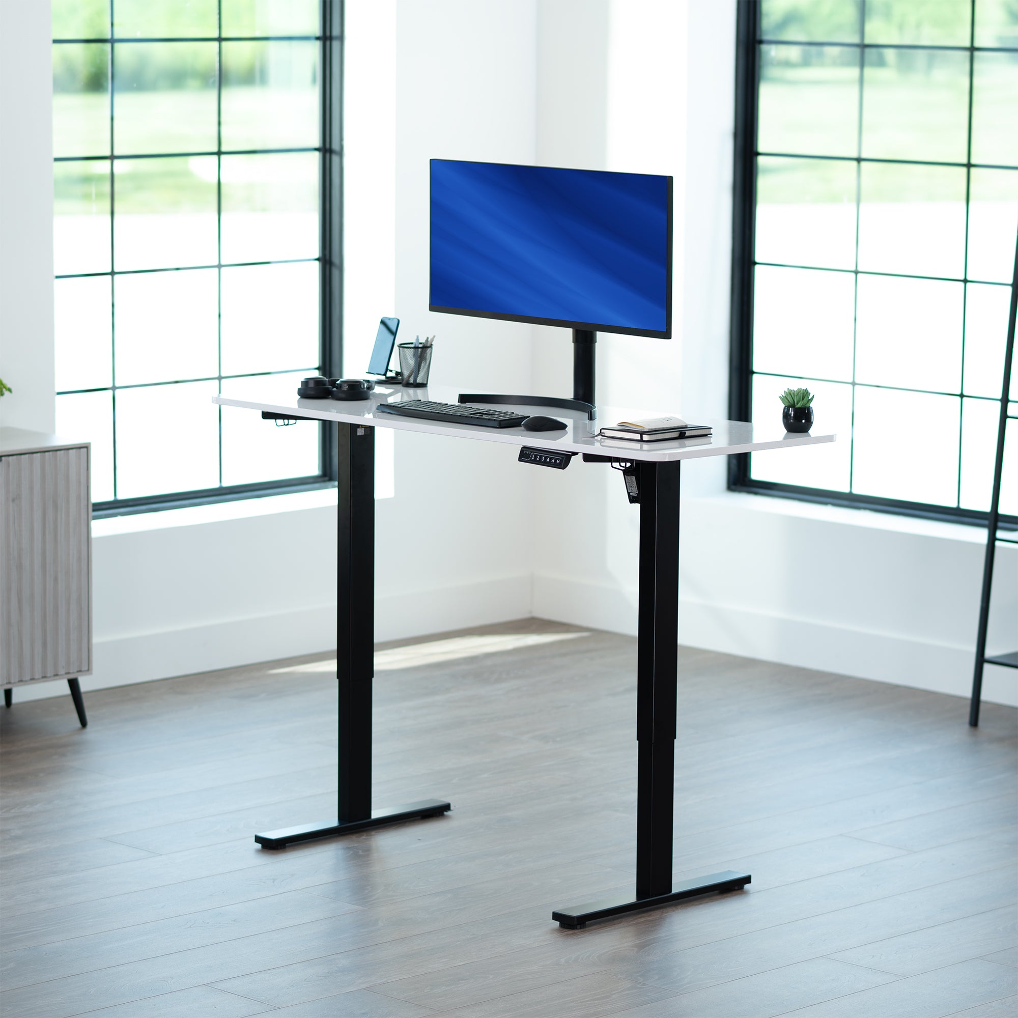 Sturdy ergonomic sit or stand active desk workstation with adjustable height using smart control panel.