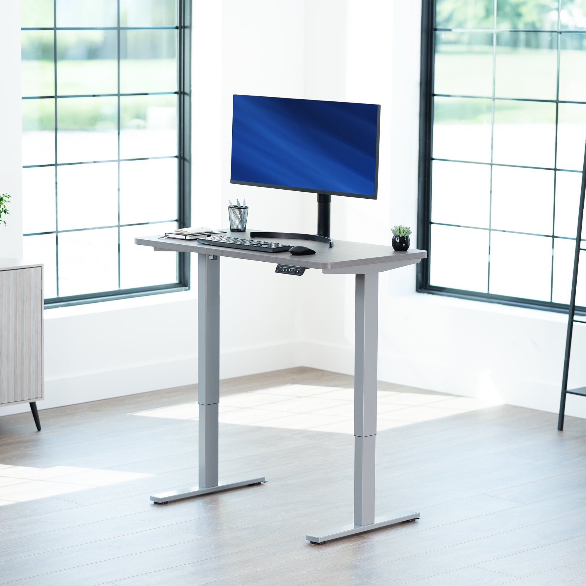 Sturdy ergonomic sit or stand active desk workstation with adjustable height using smart control panel.