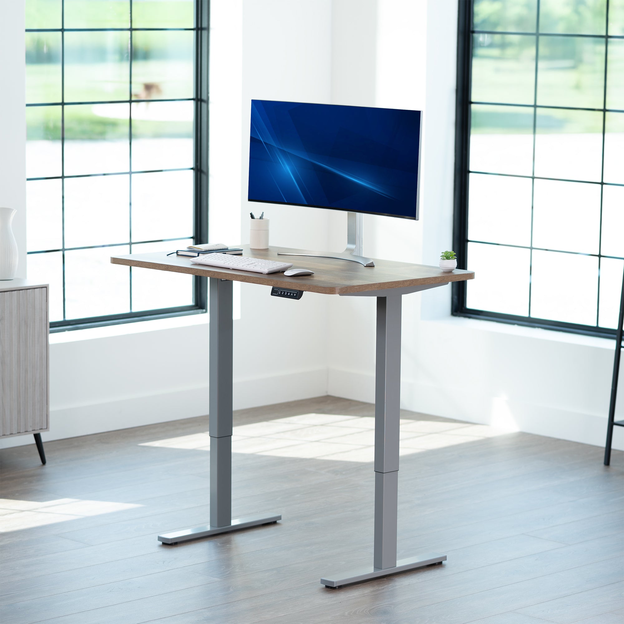 Sturdy ergonomic sit or stand active desk workstation with adjustable height using smart control panel.