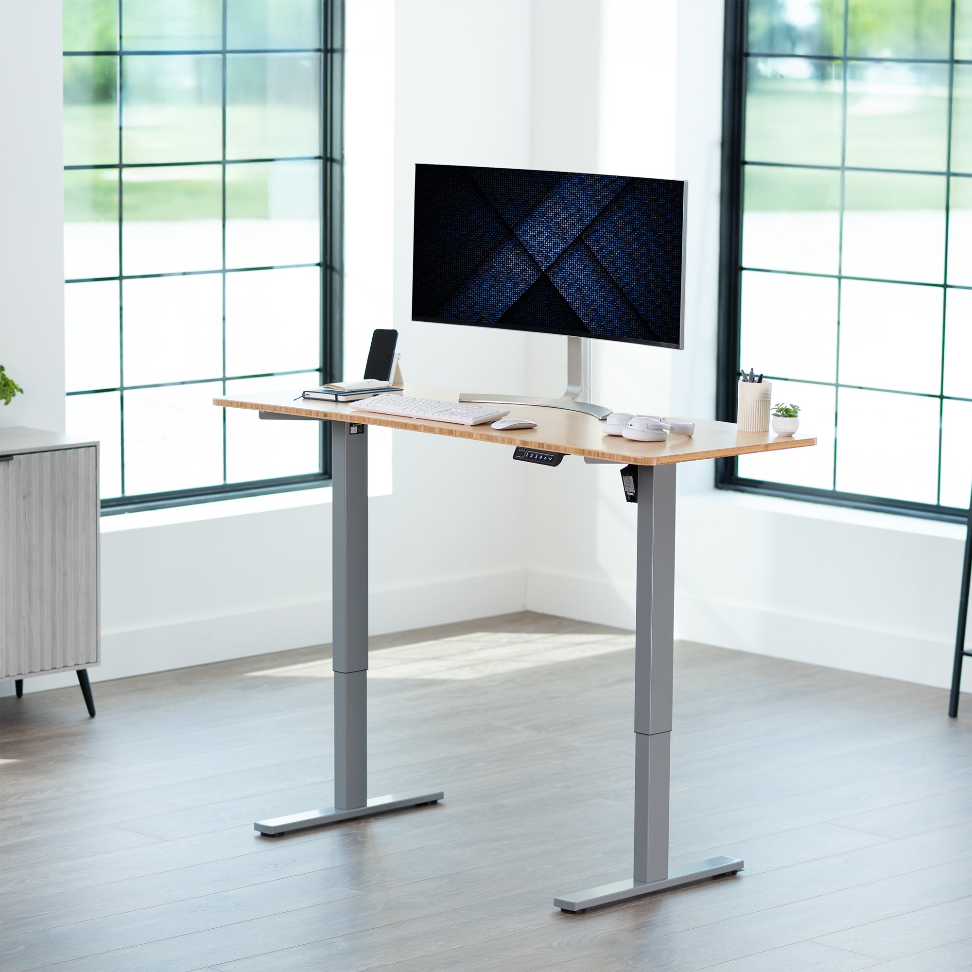 Sturdy ergonomic sit or stand active desk workstation with adjustable height using smart control panel.