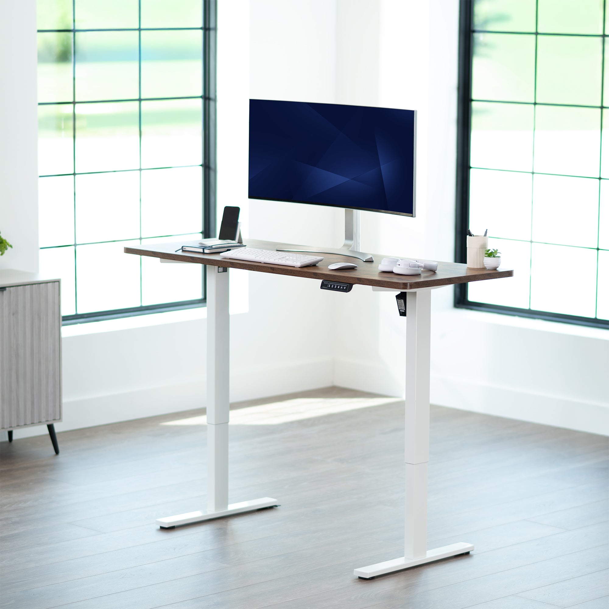 Sturdy ergonomic sit or stand active desk workstation with adjustable height using smart control panel.