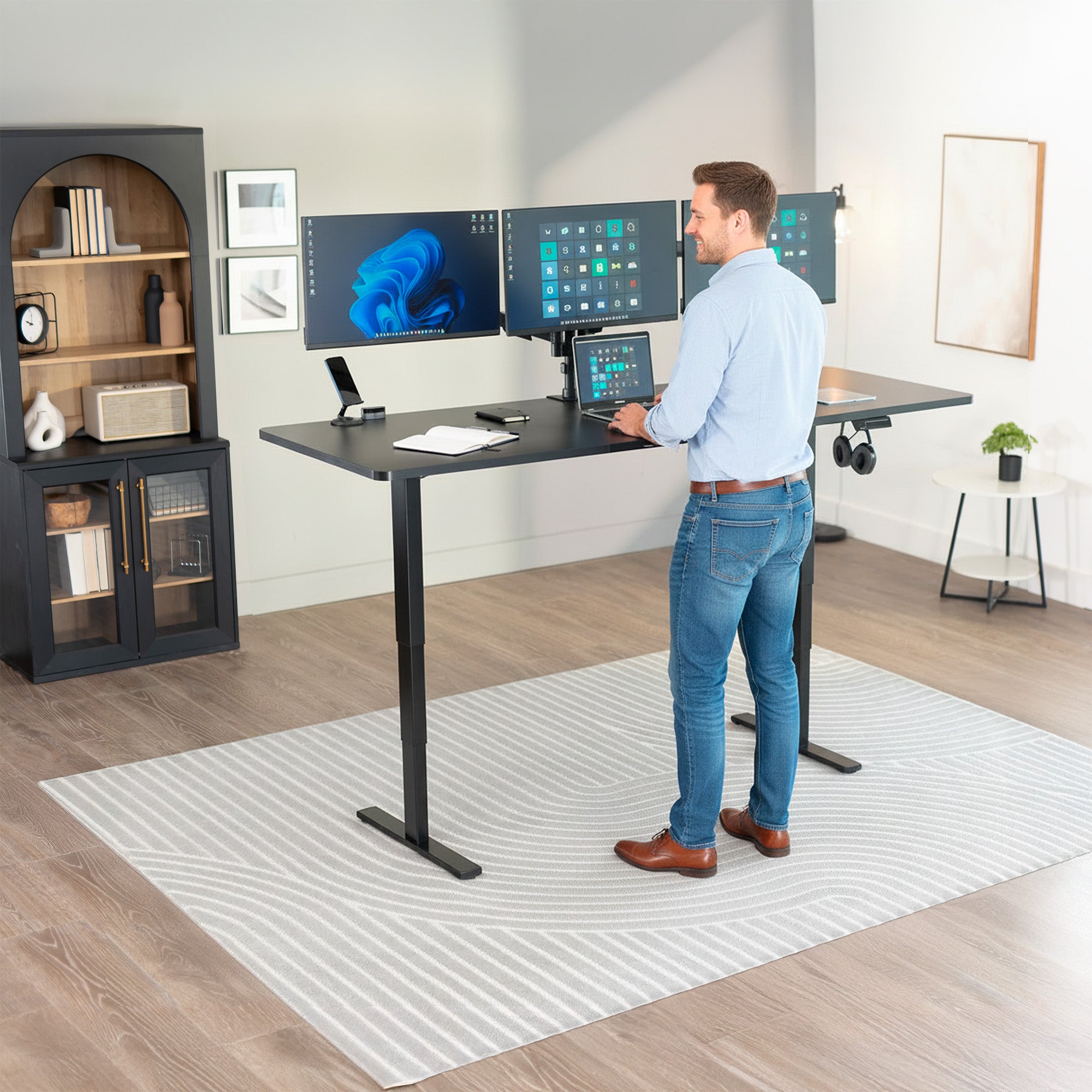 Man standing at the 2E Series - 83" x 30" Electric Desk with Touch Screen Memory Controller