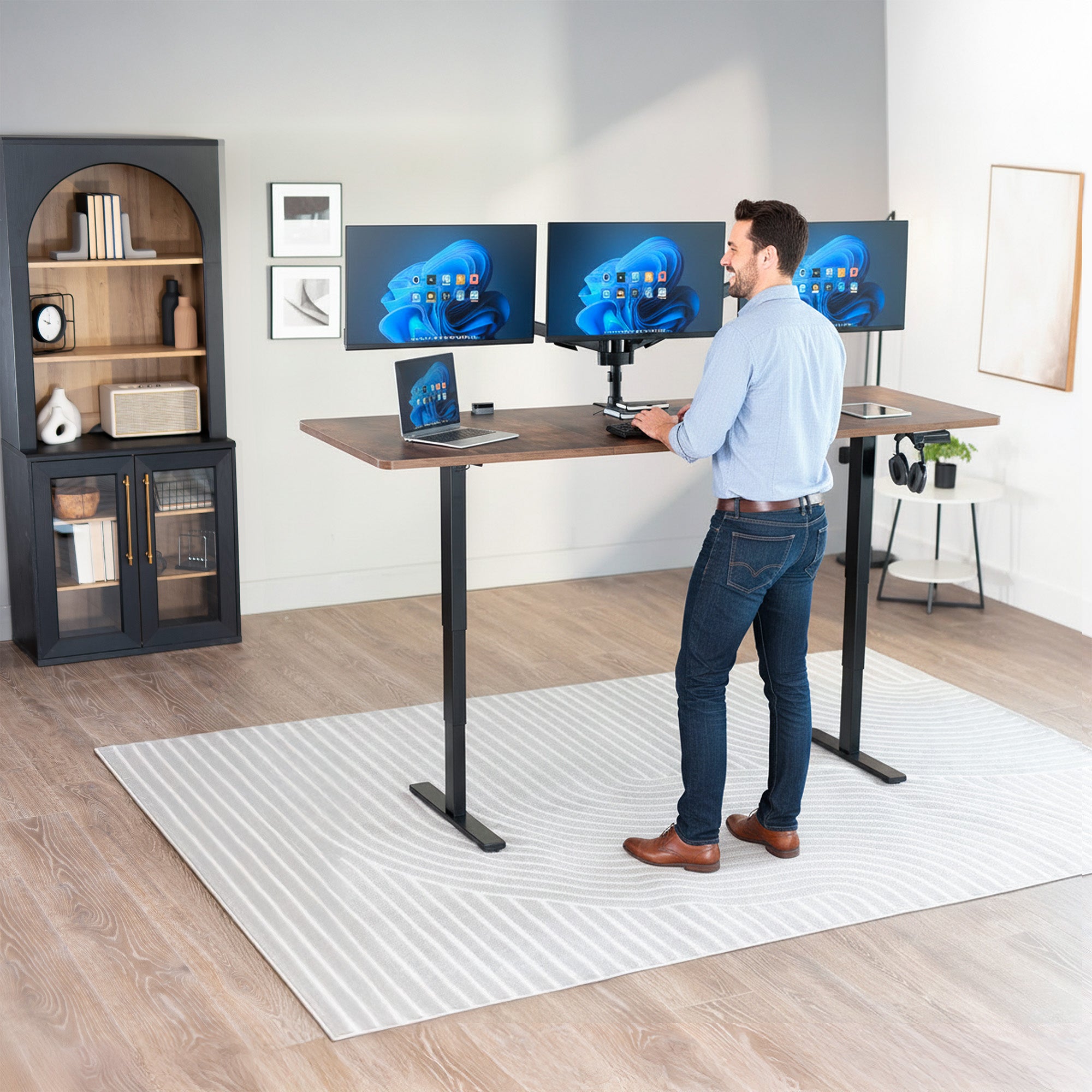 Man standing at the 2E Series - 83" x 30" Electric Desk with Touch Screen Memory Controller