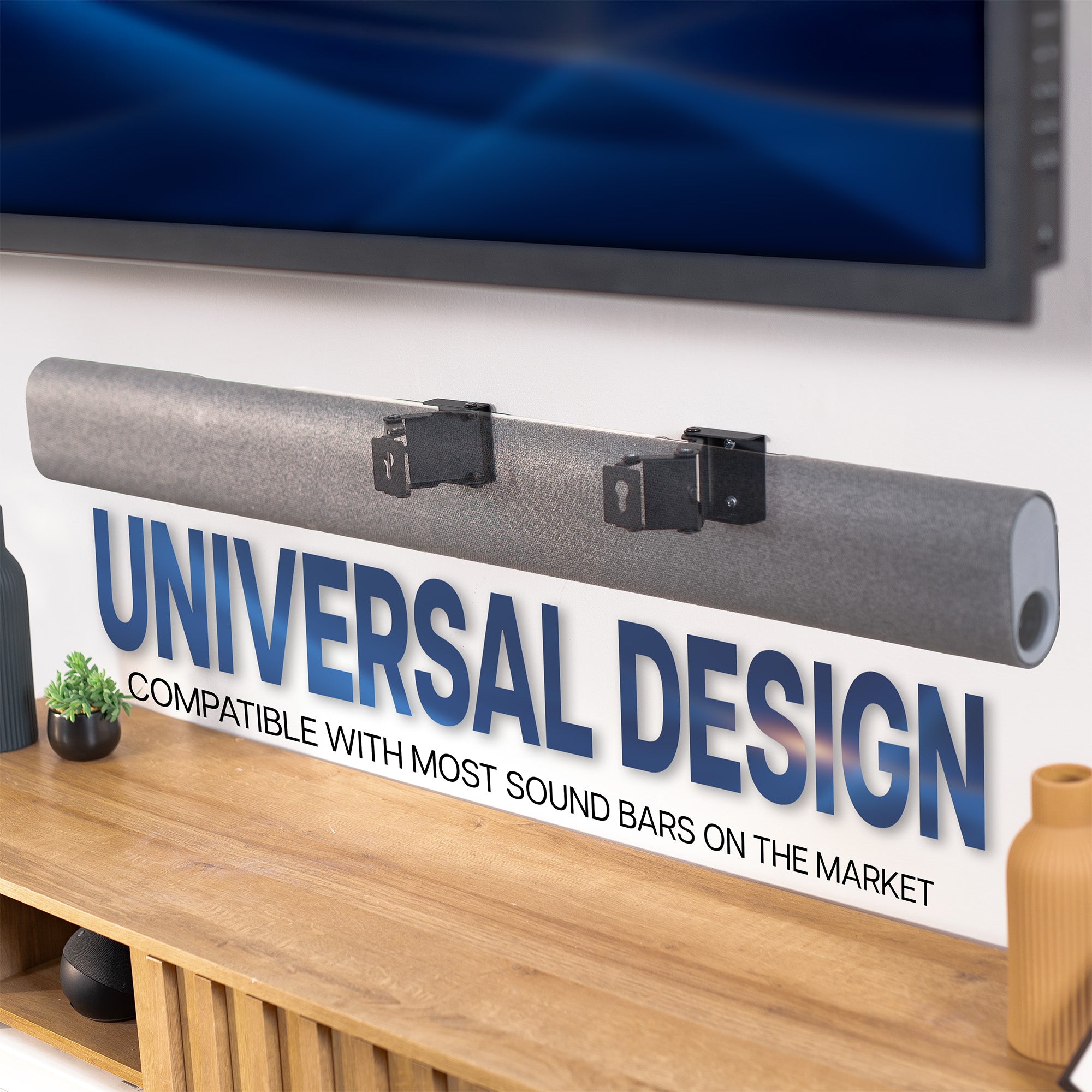 Sound bar with 'Universal Design' label in front of a television on a sound bar wall mount.