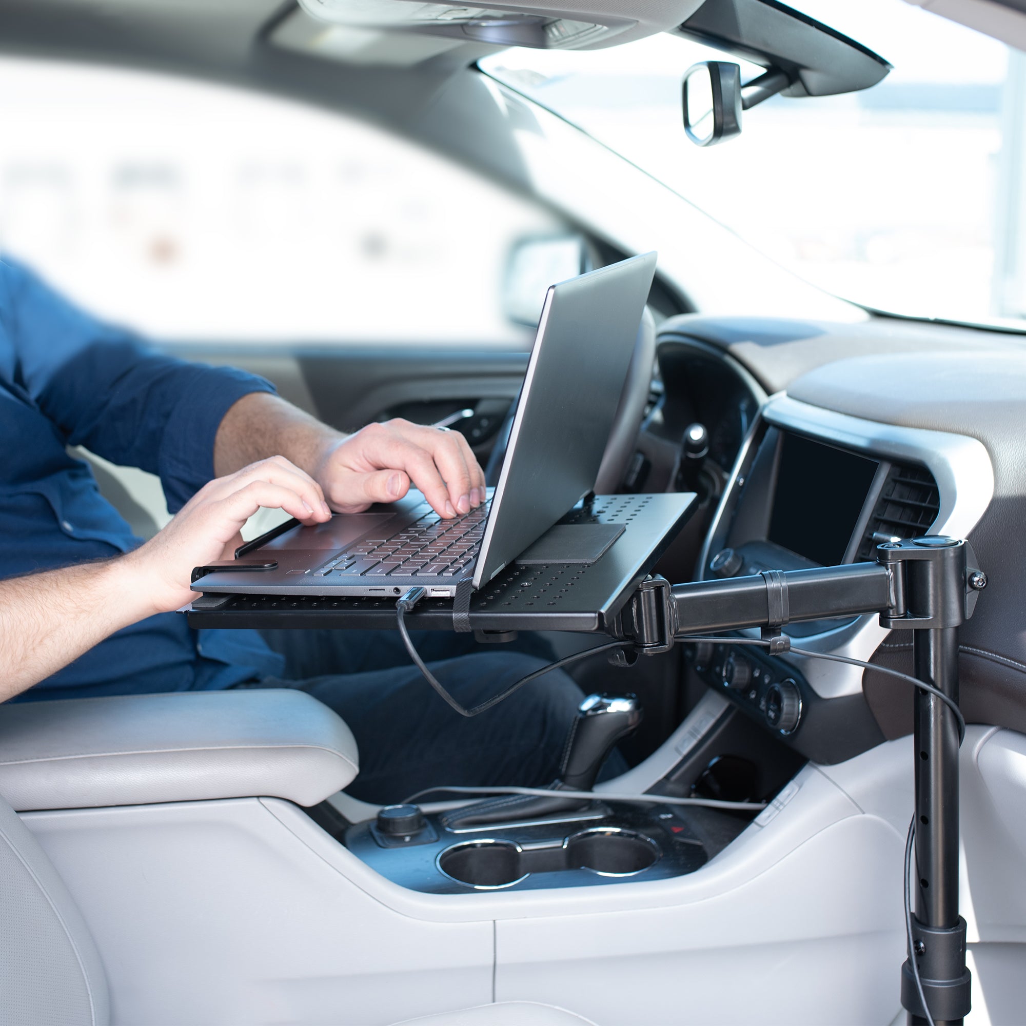 Perfect for on-the-go use, this car laptop stand anchors to the seat bolts on the passenger side chair, providing a secure and sturdy workstation.