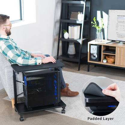 Mobile adjustable PC cart with storage and padded surface.