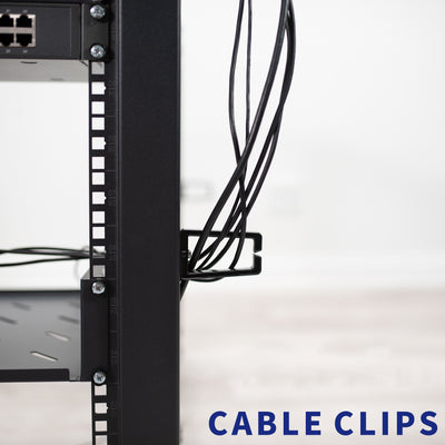 Cable clips holding black cables in a server rack against a blurred background