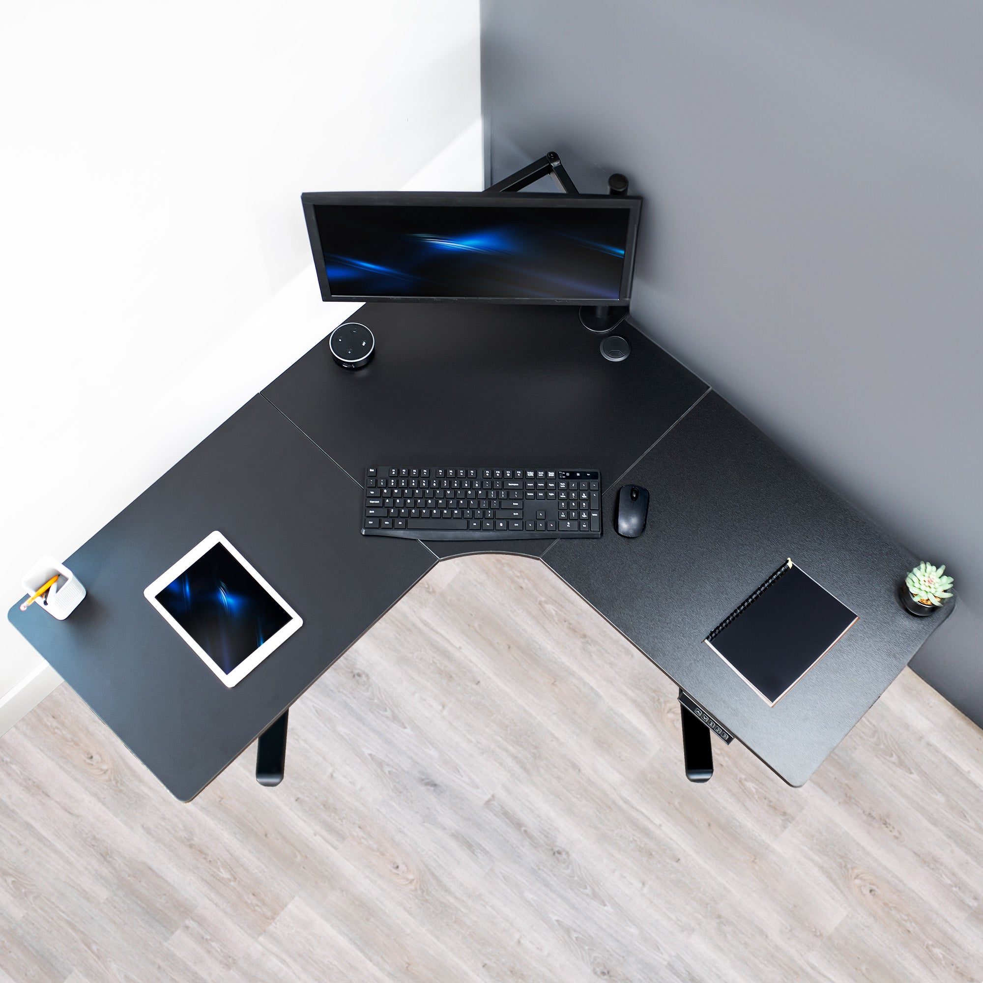 Heavy-duty electric height adjustable corner desk workstation for active sit or stand efficient workspace.