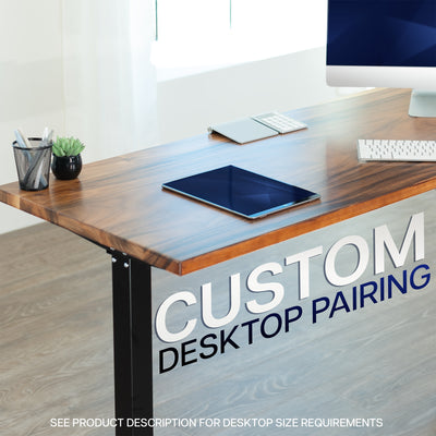 Wooden desk with computer setup and text 'Custom Desktop Pairing' on a blurred office background.