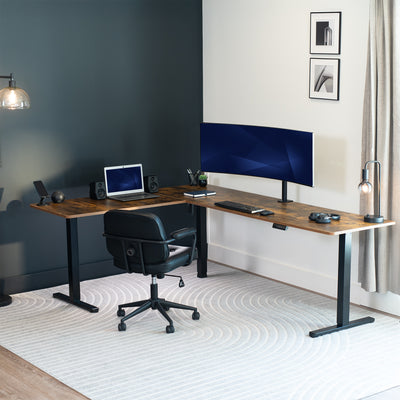 Modern home office with a L-shaped desk, computer setup, and chair.