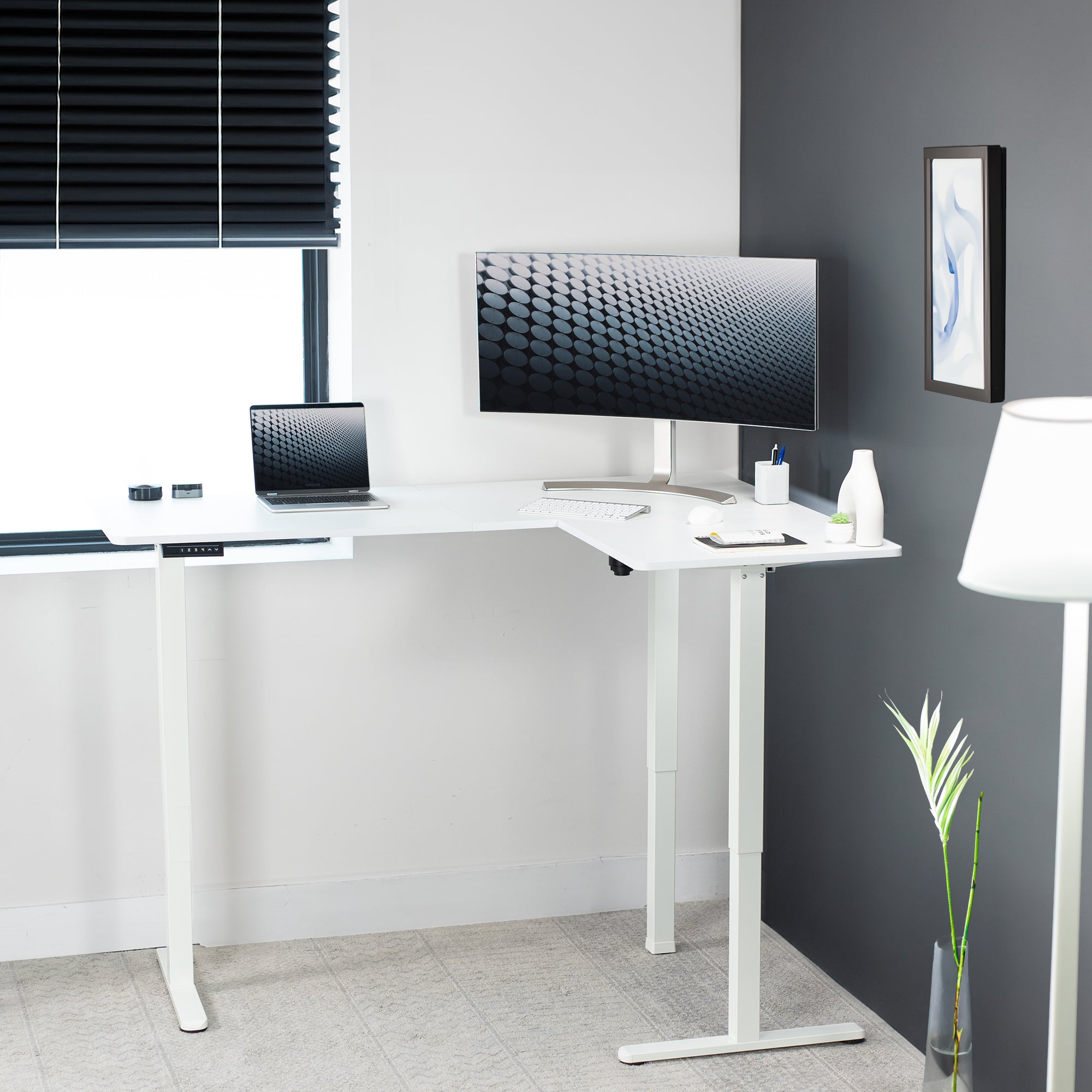 Electric heavy-duty corner desk workstation for modern office workspaces.