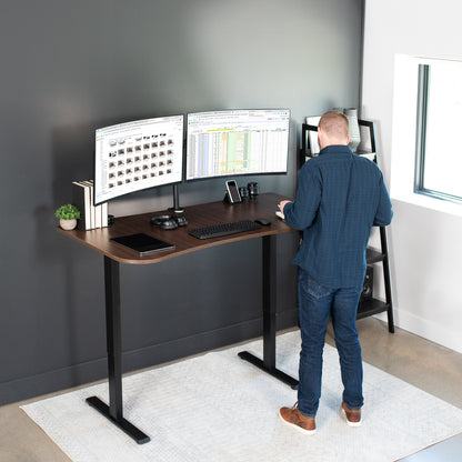 Sit to stand height adjustable electric desk with push button memory controller for ergonomic office workstation.