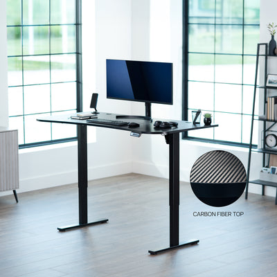 Carbon fiber, electric, sit to stand, height adjustable desk in office setting.