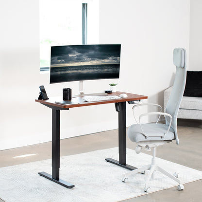 Sturdy ergonomic sit or stand active desk workstation with adjustable height using smart control panel.