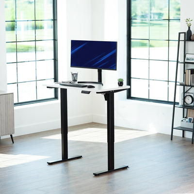 Sturdy ergonomic sit or stand active desk workstation with adjustable height using smart control panel.