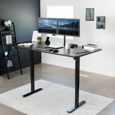 Spacious light wood electric sit-to-stand desk.