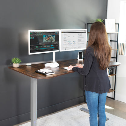 Rustic sit to stand height adjustable electric desk with push button memory controller for ergonomic office workstation.