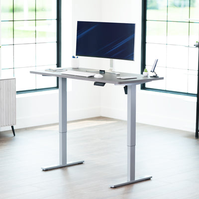 Sturdy ergonomic sit or stand active desk workstation with adjustable height using smart control panel.
