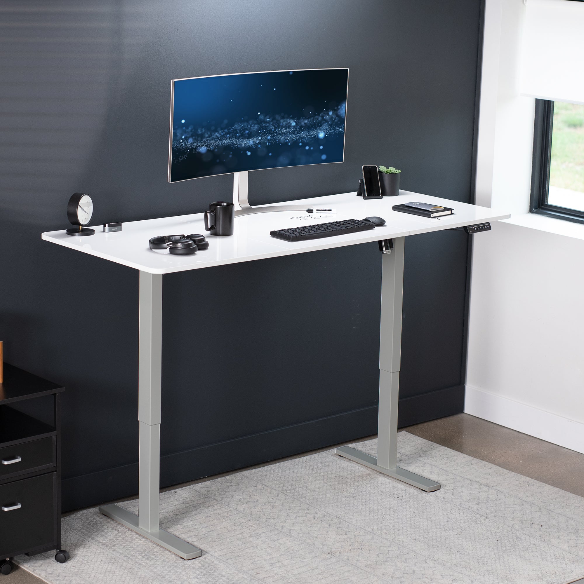 Large sturdy sit or stand dry erase desktop workstation with adjustable height using smart control panel.