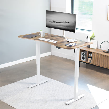 Sit to stand height adjustable electric desk with push button memory controller for ergonomic office workstation.