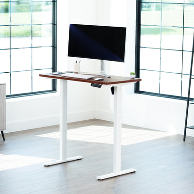 Sturdy ergonomic sit or stand active desk workstation with adjustable height using smart control panel.