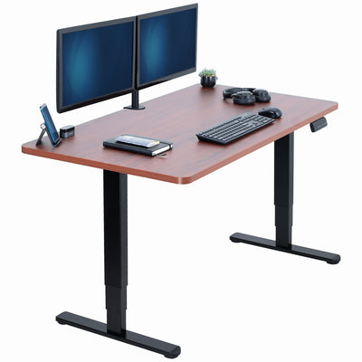 Wooden desk with black legs, two monitors, keyboard, and mouse on a white background