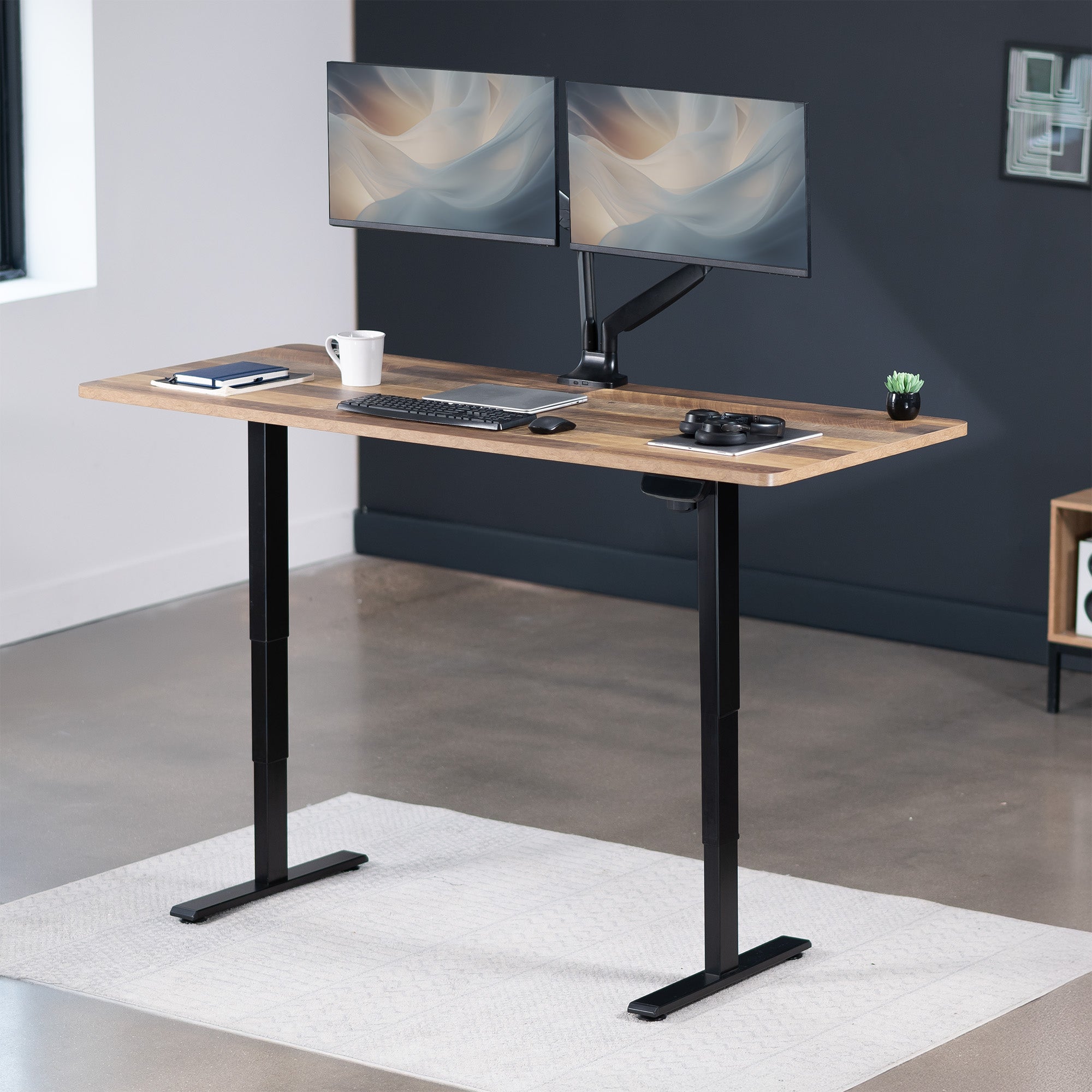 Heavy-duty electric height adjustable desktop workstation for active sit or stand efficient workspace.