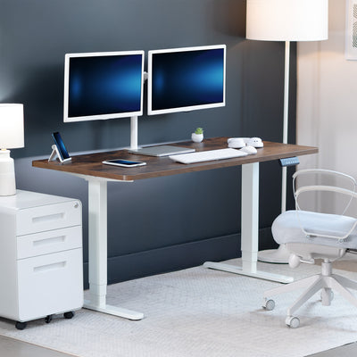Modern office setup with a adjustable desk, computer monitors, and office chair.