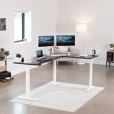 Large electric heavy-duty corner desk workstation for modern office workspaces.