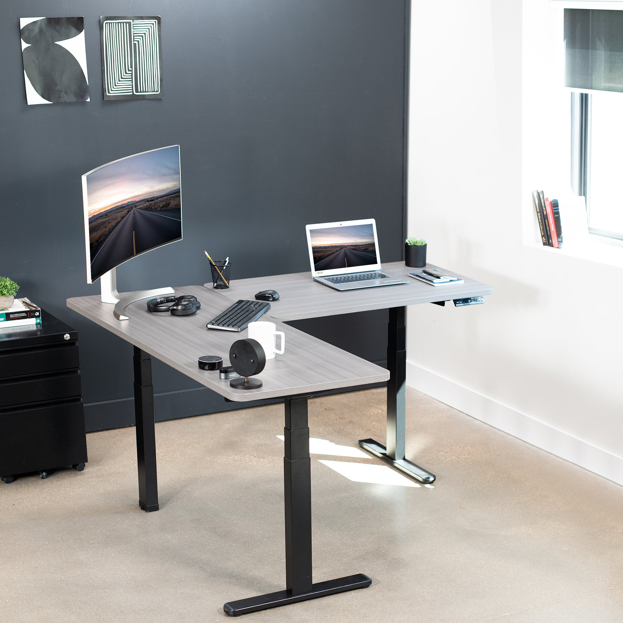 Heavy-duty electric height adjustable corner desk workstation for active sit or stand efficient workspace.