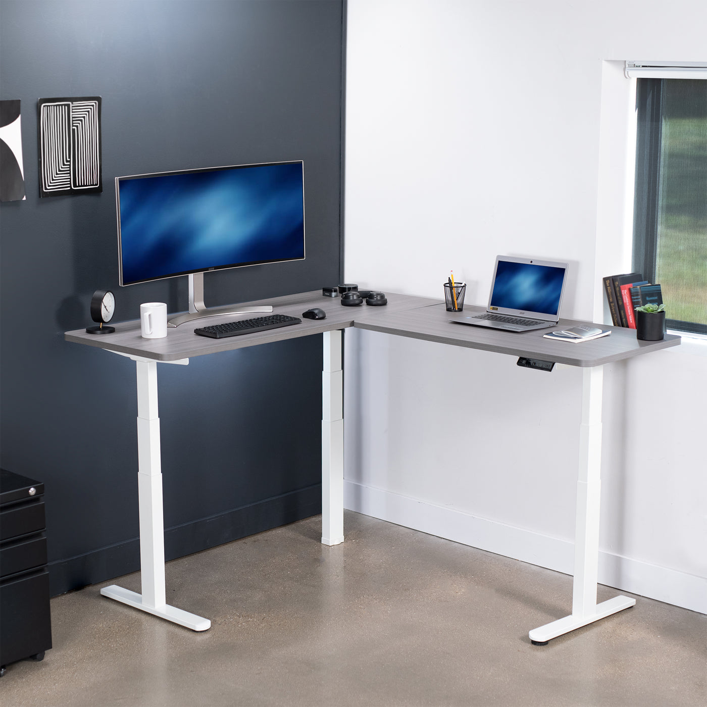 Heavy-duty electric height adjustable corner desk workstation for active sit or stand efficient workspace.