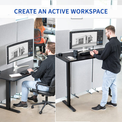 Person using a standing desk with multiple computer monitors in an office setting.
