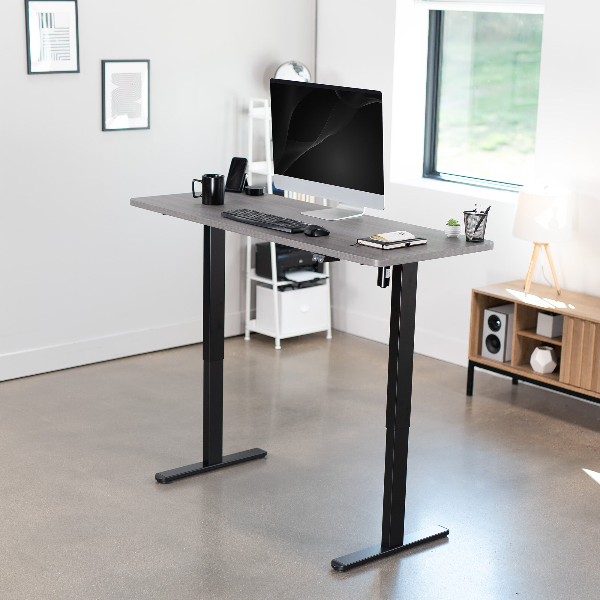 Heavy-duty electric height adjustable desktop workstation for active sit or stand efficient workspace.