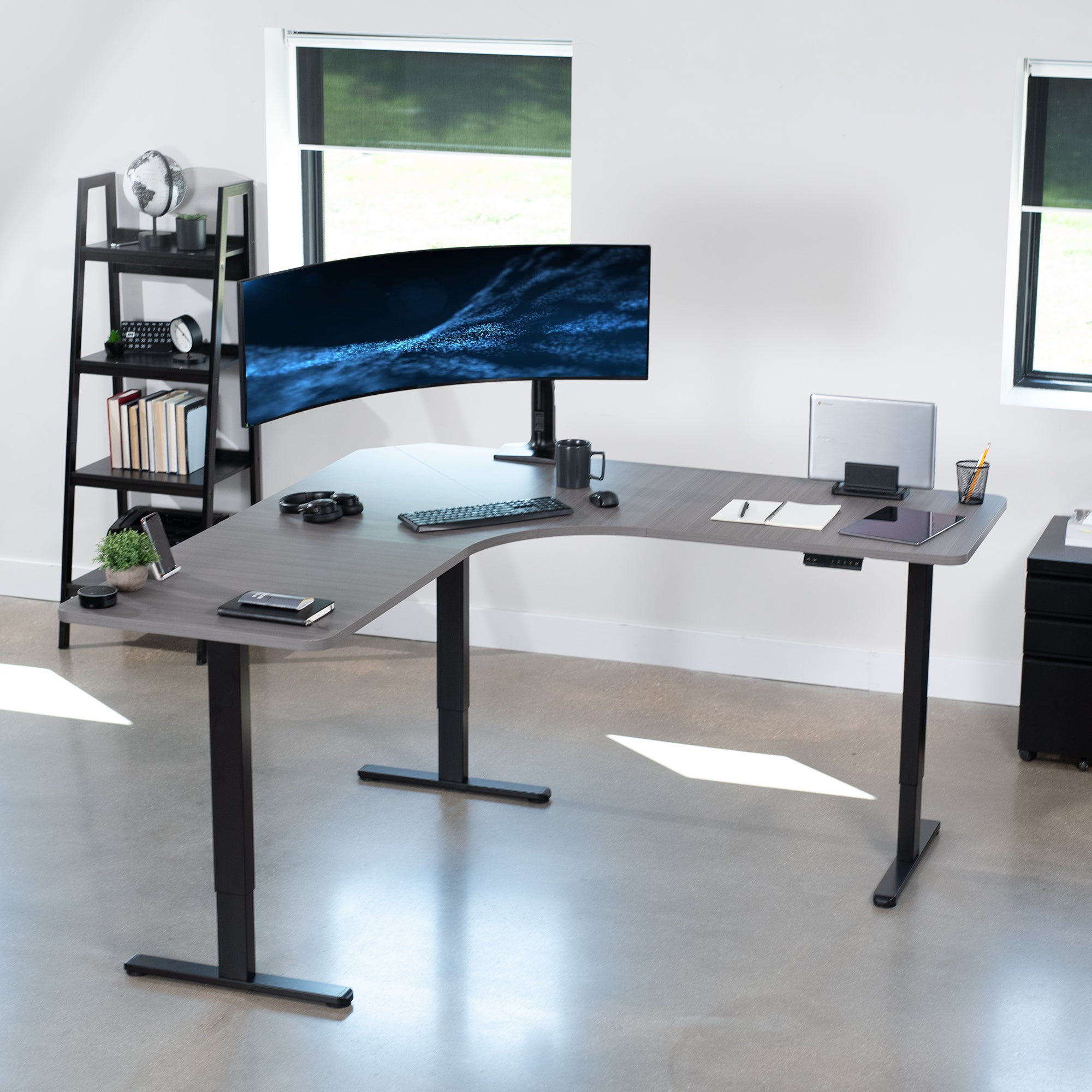 Large heavy-duty electric height adjustable corner desk workstation with programmable memory controller.