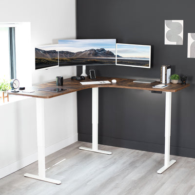 Large, rustic, heavy-duty electric height adjustable corner desk workstation with programmable memory controller.