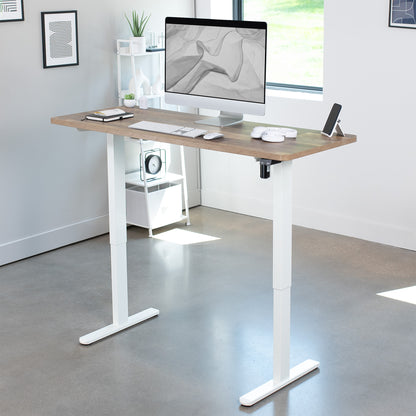 Heavy-duty wood plank pattern electric height adjustable desktop workstation for active sit or stand efficient workspace.