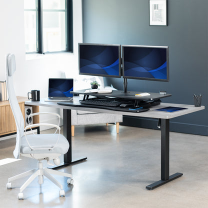 42 inch height adjustable desk riser with articulating pneumatic dual monitor mount.