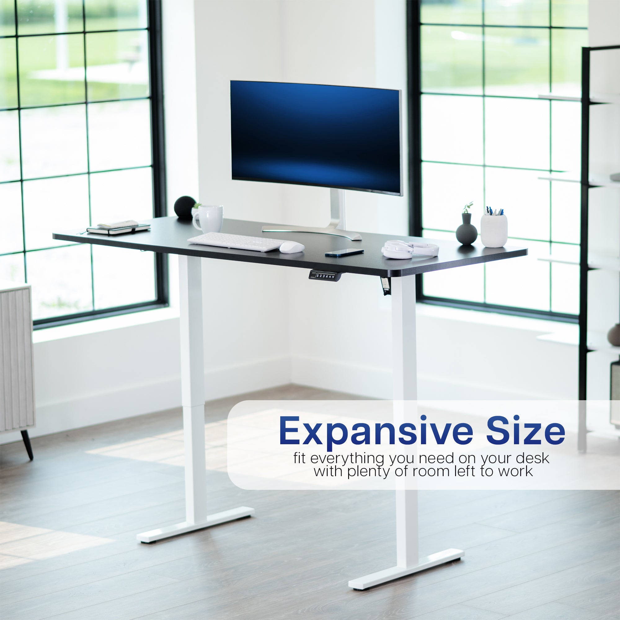 Modern office desk with a computer monitor in a bright room.