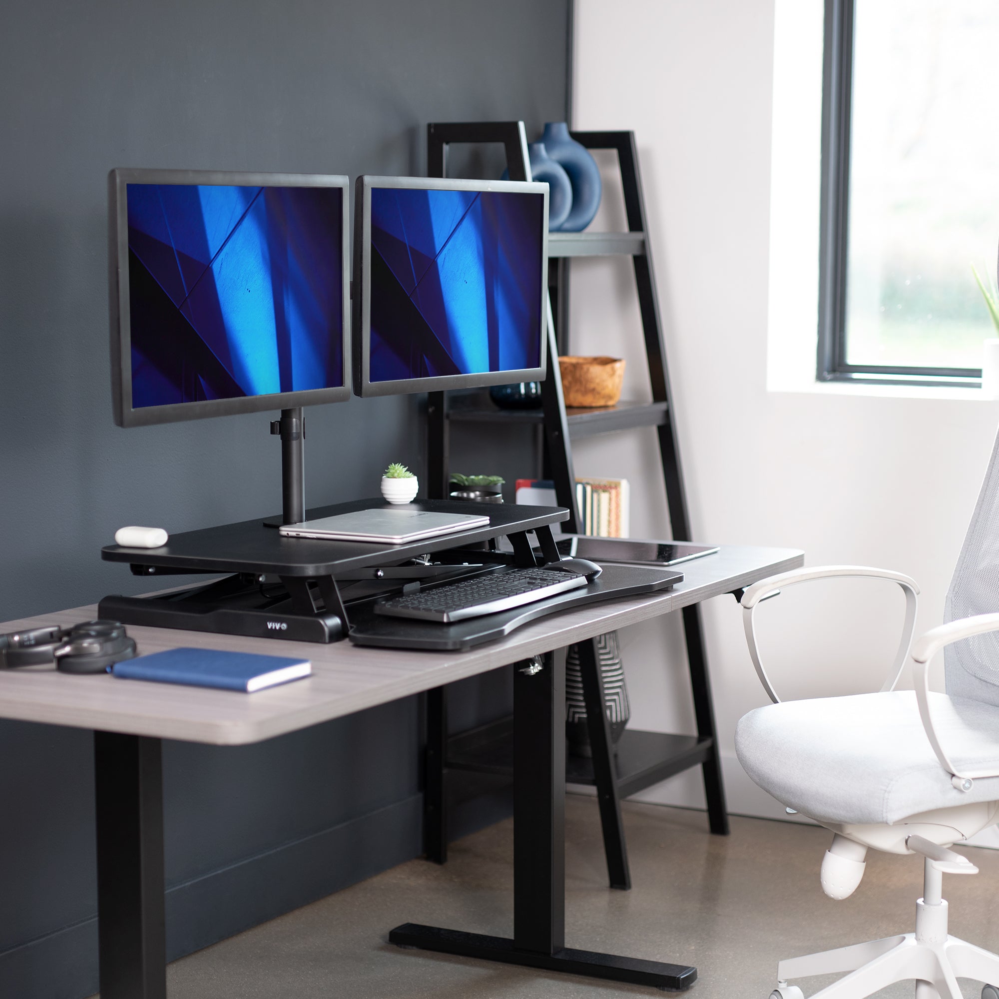 Sturdy height adjustable desk converter with articulating dual monitor mount.