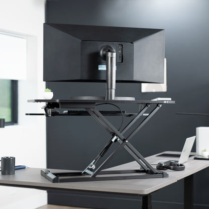 Heavy-duty height adjustable desk converter monitor riser with 2 tiers.