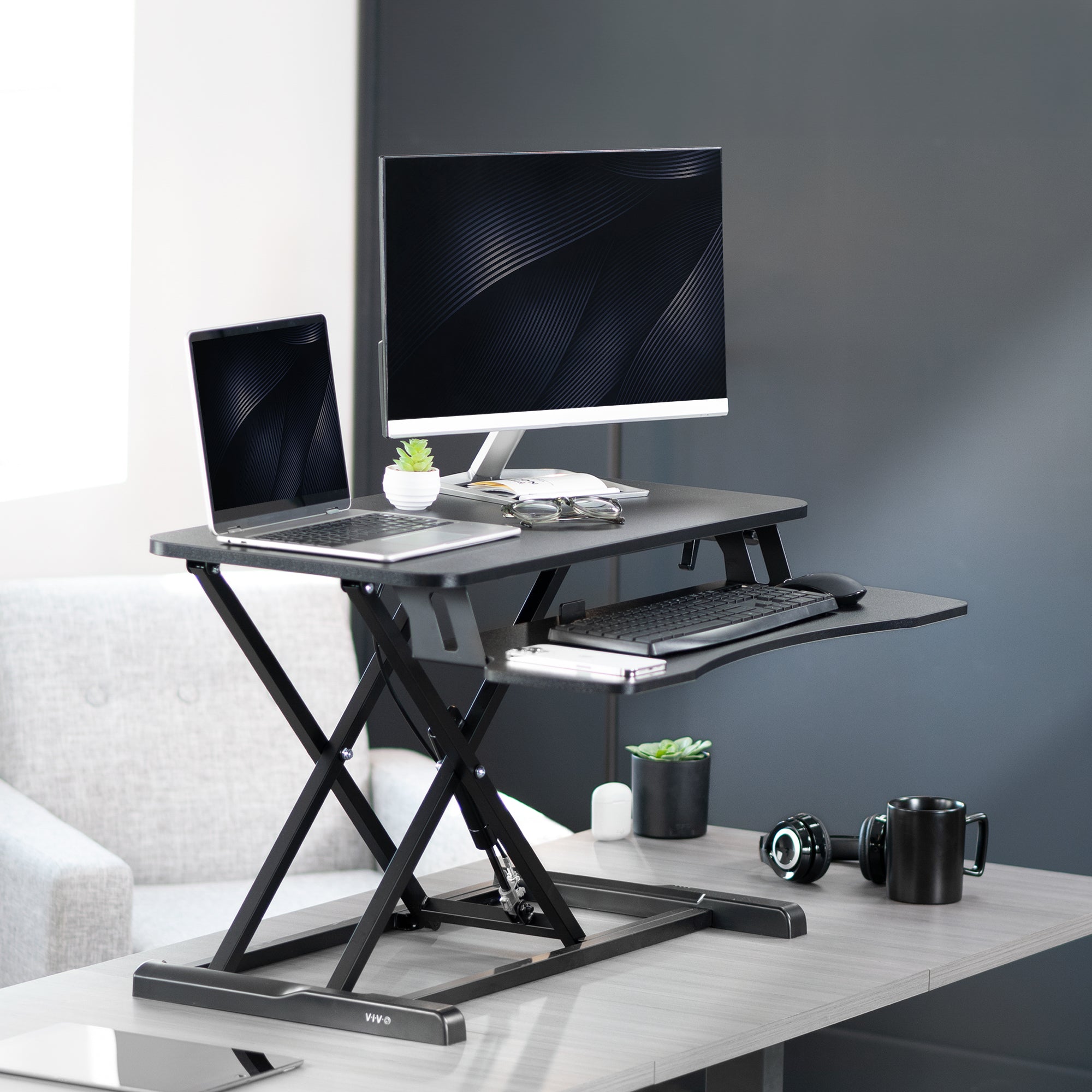 Sturdy height adjustable 2-tiered desk riser for ergonomic office workstation.