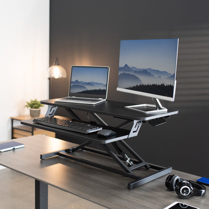 Heavy-duty height adjustable desk converter monitor riser with 2 tiers.