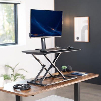 Heavy-duty height adjustable desk converter monitor riser.