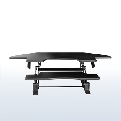 Two-tier tabletop desk riser with two monitors and a laptop.