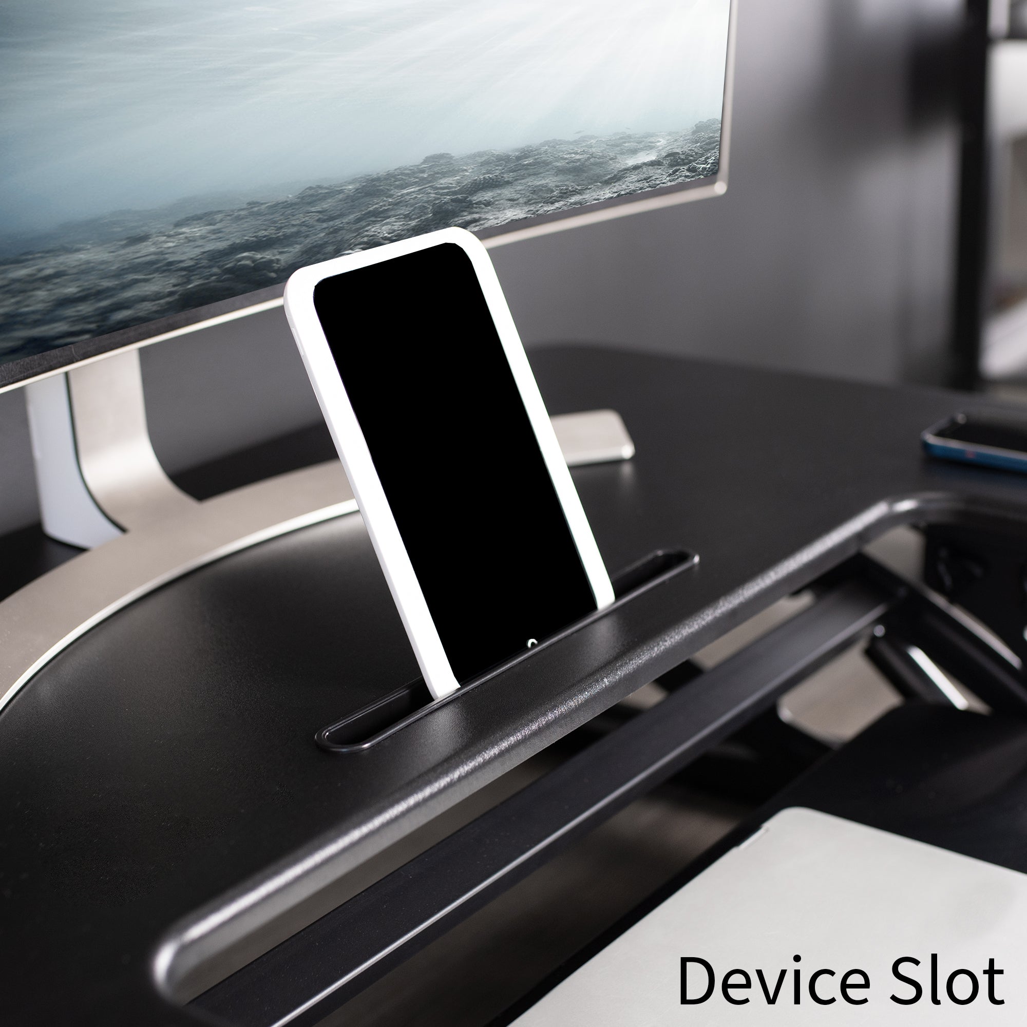 Device slot on Dual-tiered, electric desk riser that sits on top of your current desk.