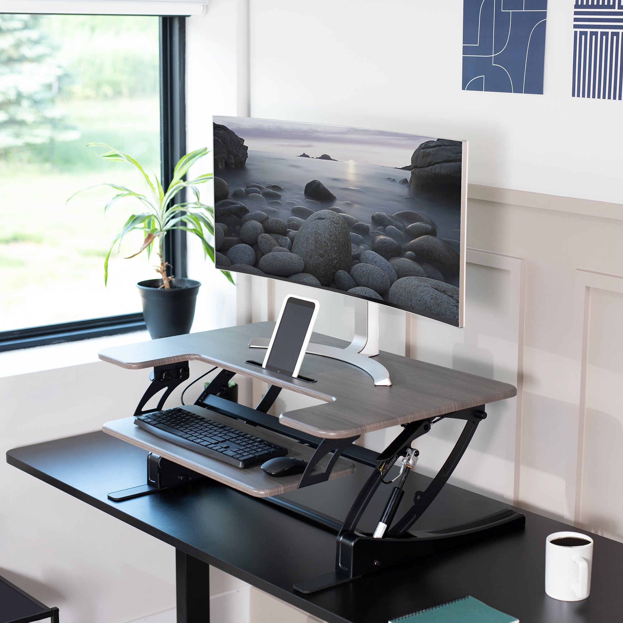 Heavy-duty height adjustable desk converter monitor riser with 2 tiers.