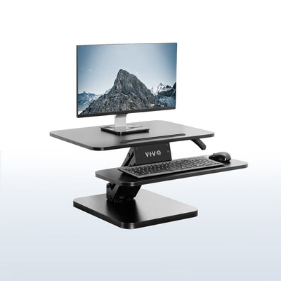 Sit stand desk converter sits on top of current desk and raises and lowers for a comfortable viewing and typing experience.