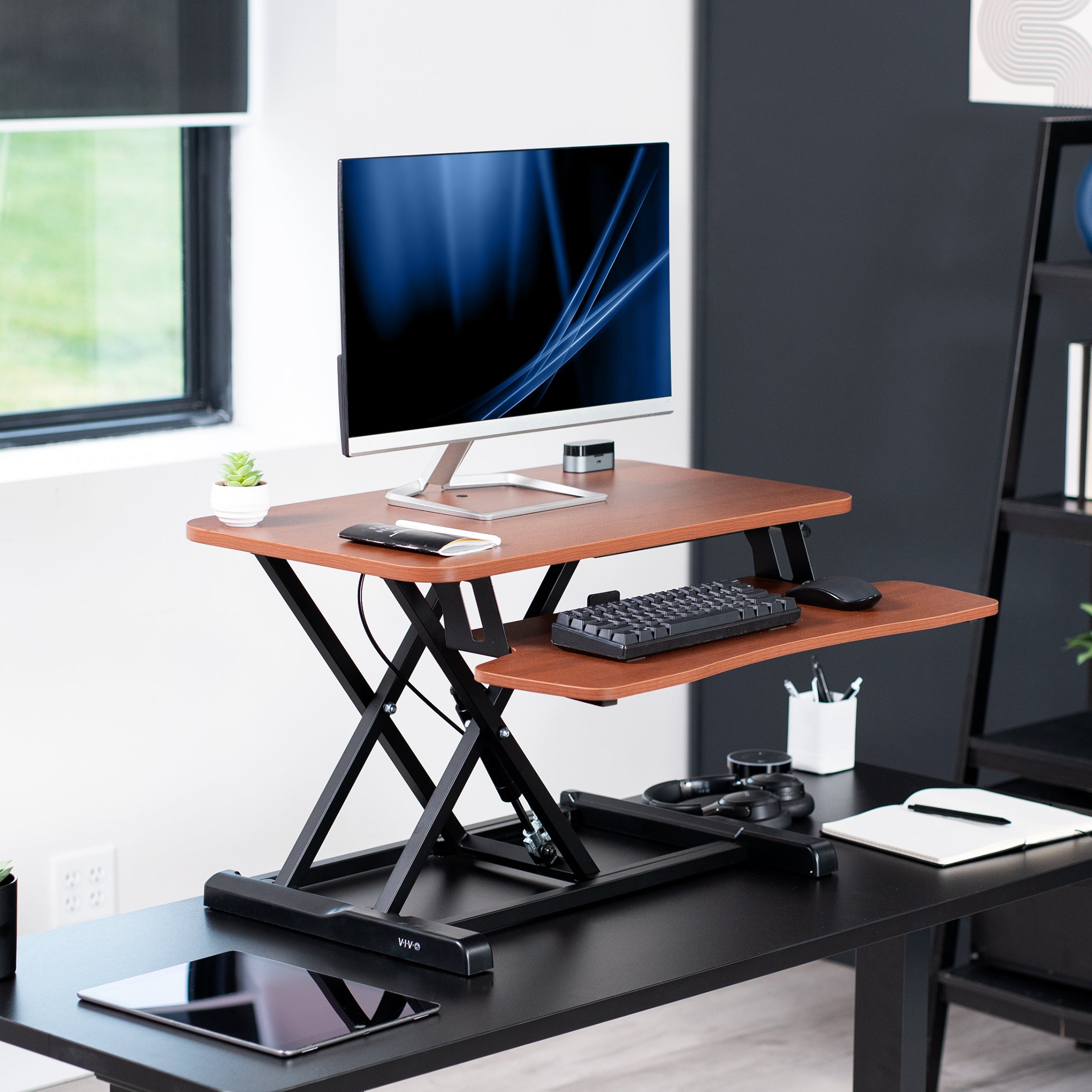 Sturdy height adjustable 2-tiered desk riser for ergonomic office workstation.