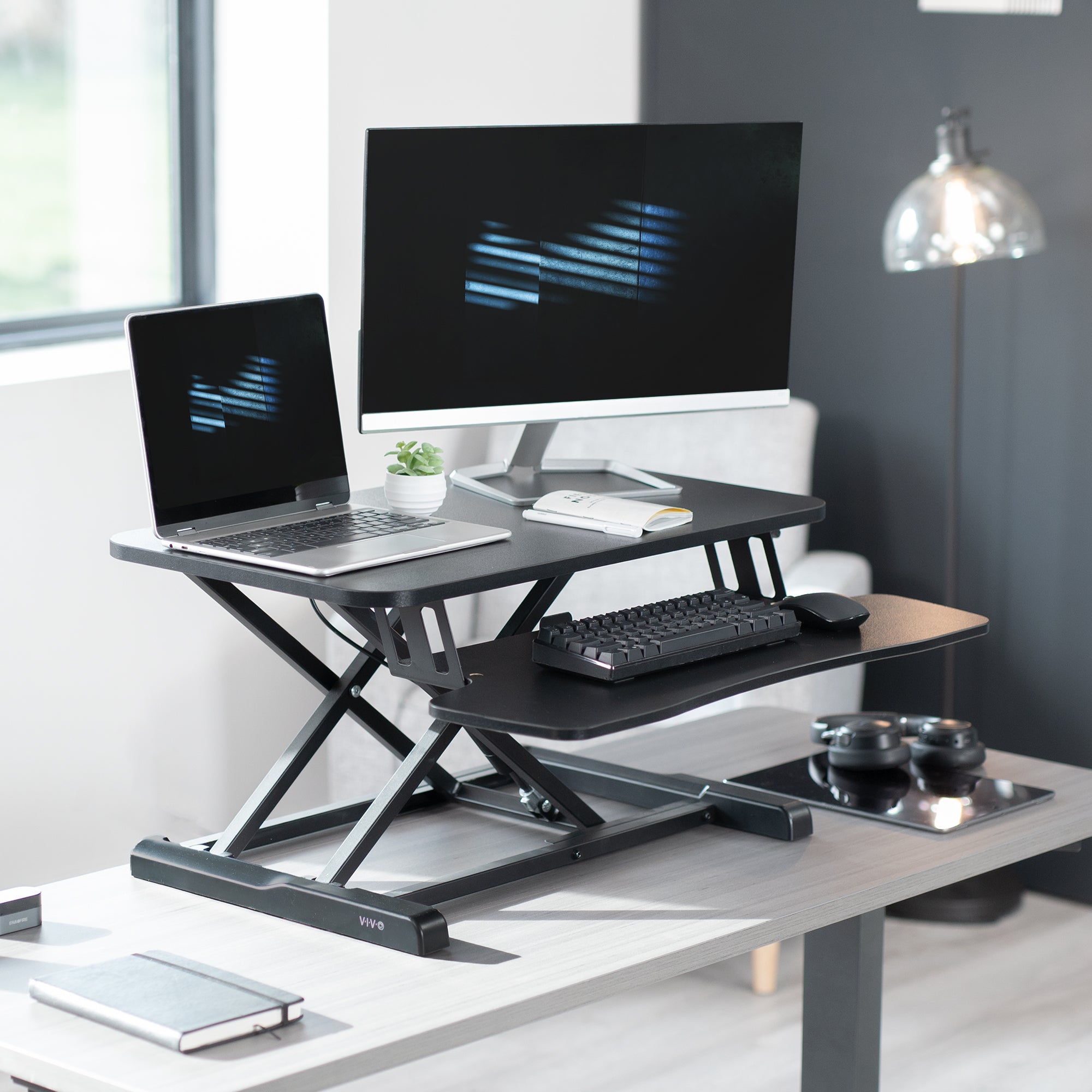 Sturdy height adjustable 2-tiered desk riser for ergonomic office workstation.