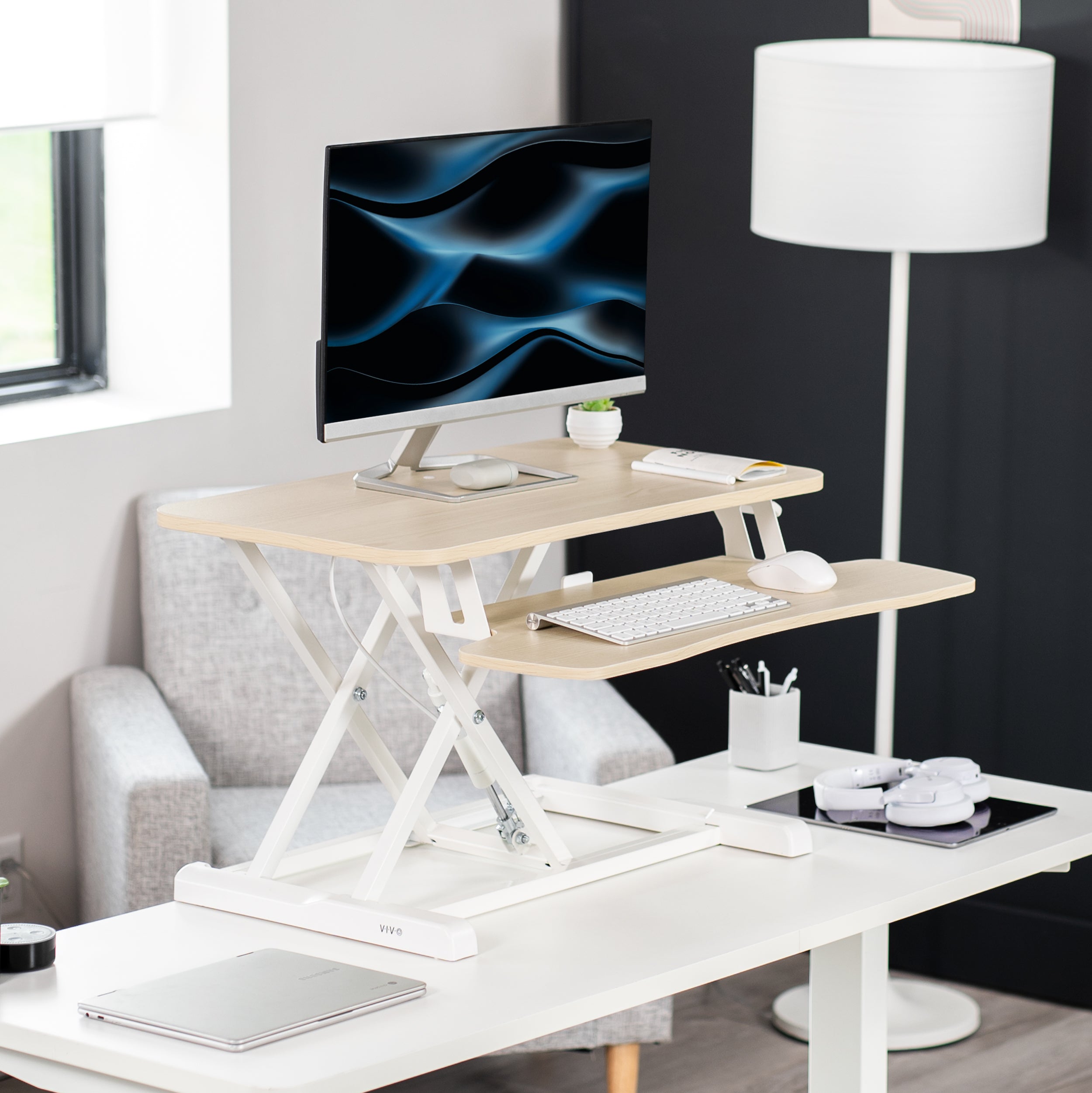 Sturdy height adjustable 2-tiered desk riser for ergonomic office workstation.